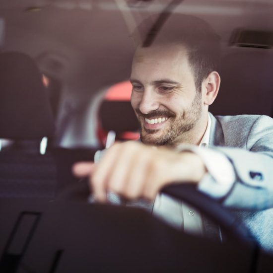 Car Owner inside vehicle enjoying the tinted windows which blocks out the Texas heat